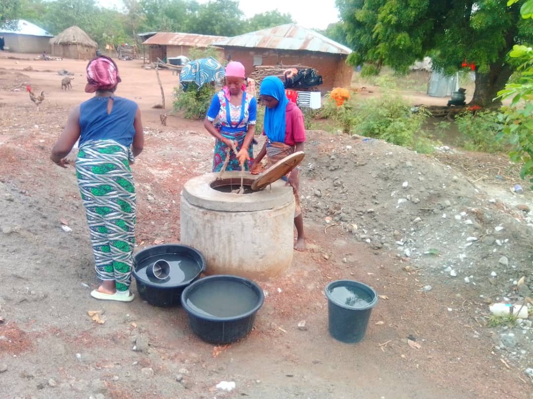 Women collecting water at a Phynai community water point